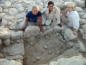Stone-lined Pit Containing Several Spherical Pounders and Grinding Stones