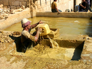 Clay being stirred up in water basin, then sieved into the next vat for settling