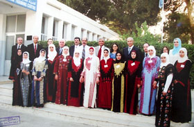 Taken from a photo presented to our team by the administration of ATC with a picture of graduation officials and graduating students (front row) who are all wearing traditional Palestinian dresses representing various towns in Palestine from which they come (photo taken 20 July 2006)