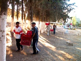 Some of our Bunayat boys schlepping crates of equipment and supplies across the campus, headed for the storeroom (photo courtesy Denise Herr)