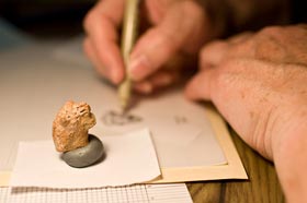 Lion-head figurine being drawn by Ronda Root