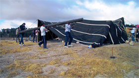 Local workers setting up the Bet Shar, our goat-hair tent