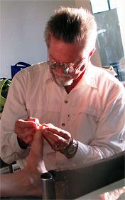 Gary Huffaker attending to a splinter in Monique Vincent’s toe