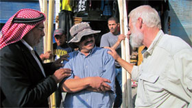 Truck driver, Romel Gharib, Doug  Clark with Abu Issa and Osama holding tent poles