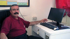 ATC Education Director, Munir with one of new computers donated by the `Umayri project