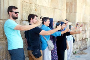 hing for the Roman Amphitheatre to open, participants pass the time by posing for selfies. 