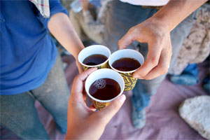 Tea time with 'Bedouin whiskey,' a brew of regular tea plus a ton of sugar, sometimes with mint