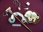 Textiles artifacts, including a basalt loom weight, bronze needle, bone spatula and ceramic and bone spindle whorls