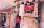 Khala, who directs the Jordanian Women's Union in the Baqa' Refugee Camp, standing at its entrance.